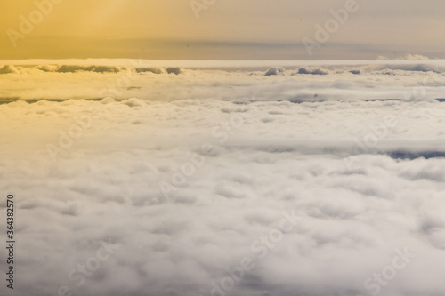 Beautiful cloudscape and blue sky from aerial view  nature view from above the sky and clouds. White clouds and blue sky view like the heaven from airplane window. Sunlight in the sky shines on clouds