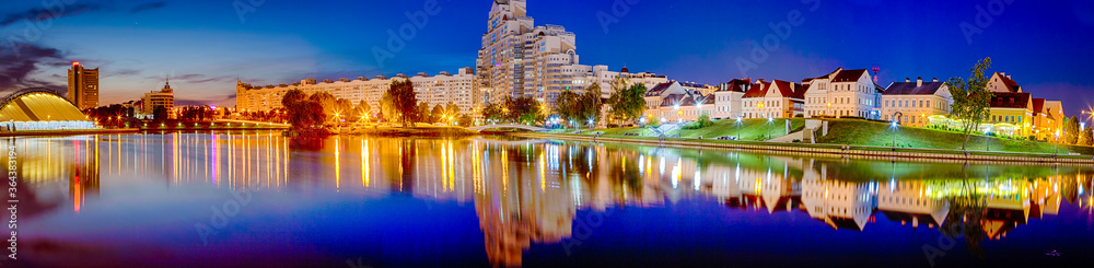 Belarus Travel Destinations. Amazing Evening View of Troicky Suburb With Svisloch River in Minsk City During Blue Hour. Picturesque Cityscape Image