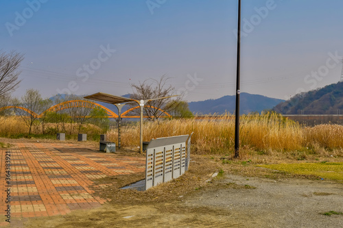 Fotografia, Obraz Bike rack and covered park benches