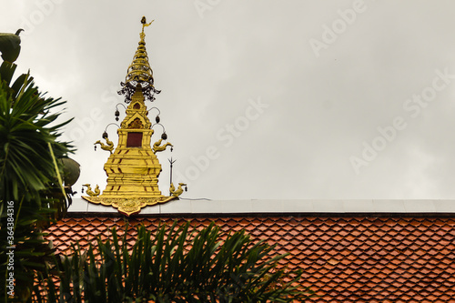 Beautiful swan sculptures on the church roof under the blue sky background at Wat Phra That Doi Prabat (Wat Doi Phra Baht) in Chiang Rai, Thailand. photo