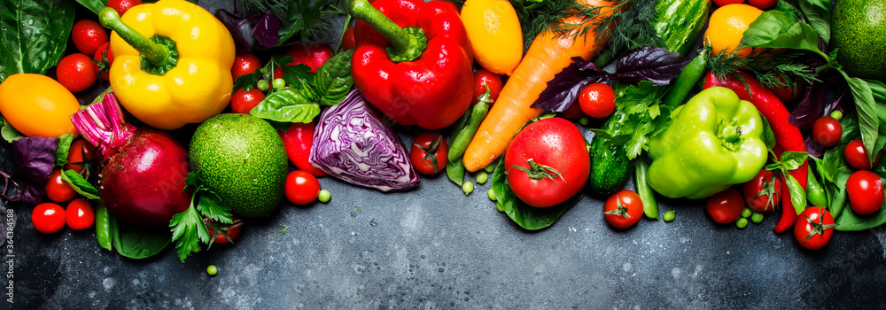 Food, healthy and useful multicolored vegetable and herbs on gray background, top view. Panoramic banner with copy space Food, healthy and useful multicolored vegetable and herbs on gray background, top view. Panoramic banner with copy space