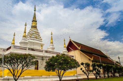 Beautiful landscape and white gold pagoda of Wat Jedyod, Chiang Rai, Thailand. Wat Chet Yot is a temple that has been renovated from the remains of an ancient temple. photo