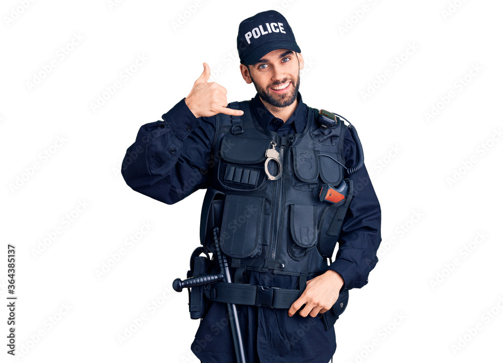 Young handsome man with beard wearing police uniform smiling doing phone gesture with hand and fingers like talking on the telephone. communicating concepts. Young handsome man with beard wearing police uniform smiling doing phone gesture with hand and fingers like talking on the telephone. communicating concepts.