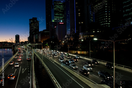 Traffic in and out of Brisbane Australia at night. Photo near the Brisbane river bridge with city lights in the background © Khaleel