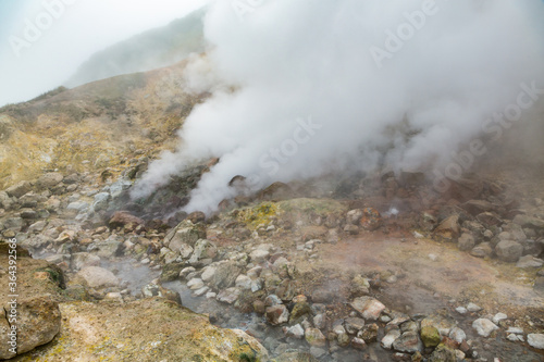 Picturesque view of volcanic landscape, aggressive hot spring, erupting fumarole, gas-steam activity in crater active volcano. Scenery mount landscape, travel destinations for hike, active vacation.