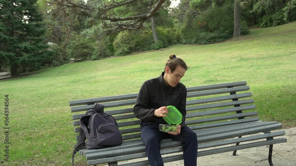 Reusable glass container and water bottle for lunch break. Zero waste travel. Eco Tourism. Eco-Friendly Lifestyle. Sustainable Living. A man eats healthy home-cooked food, baked diet vegetable Reusable glass container and water bottle for lunch break. Zero waste travel. Eco Tourism. Eco-Friendly Lifestyle. Sustainable Living. A man eats healthy home-cooked food, baked diet vegetable