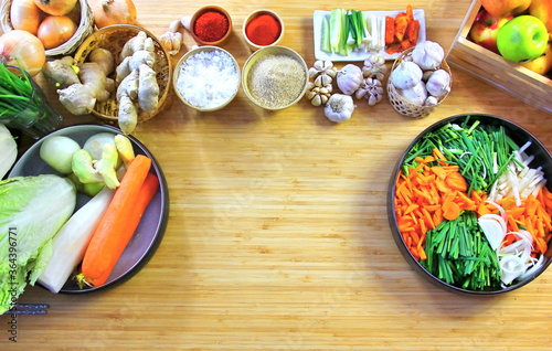 top view fresh vegetables in bowl  sugar salt chili  raw material for cooking kimchi Korea traditional foor preservation on wood table ,copy space photo