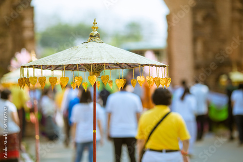 Umbrellas decorated with leaves in Kathin ceremony.