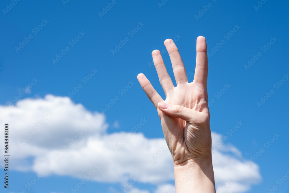 Gesture closeup of a woman's hand showing four fingers, sign language symbol number four Gesture closeup of a woman's hand showing four fingers, sign language symbol number four