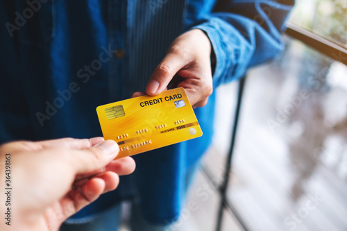 People holding and giving a credit card to someone