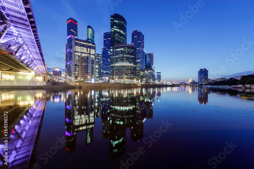 View of modern office buildings on the river bank, long exposure.