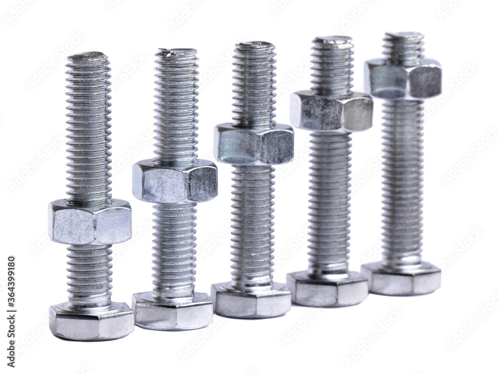 A row of metallic silver hexagon head bolts with screwed nuts closeup isolated on a white background. Steel shiny bolt with thread and nut in macro. A row of metallic silver hexagon head bolts with screwed nuts closeup isolated on a white background. Steel shiny bolt with thread and nut in macro.