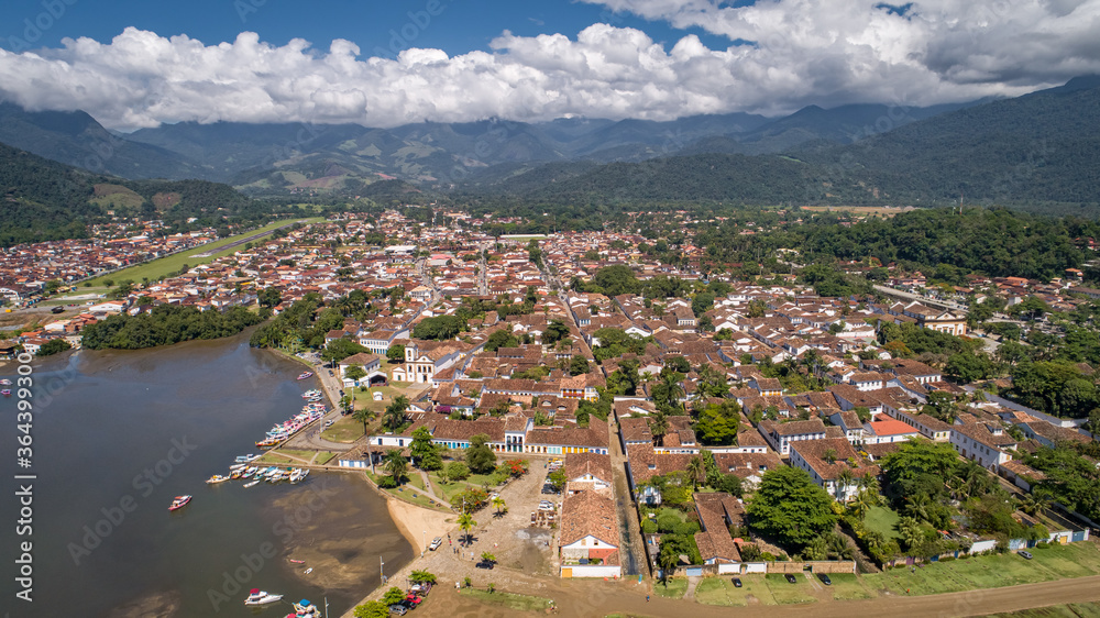Aerial view to historic town Paraty and harbour, green mountains  with white clouds in background, sunny day, Unesco World Heritage, Brazil