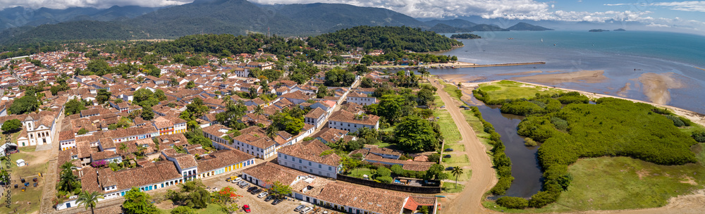 Aerial view panorama of historic town Paraty with green mountains and sea in background on a sunny day, Unesco World Heritage, Brazil