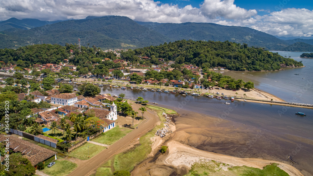 Aerial view to historic town Paraty, tidal river and Jabaquara with green mountains in background on a sunny day, Brazil, Unesco World Heritage