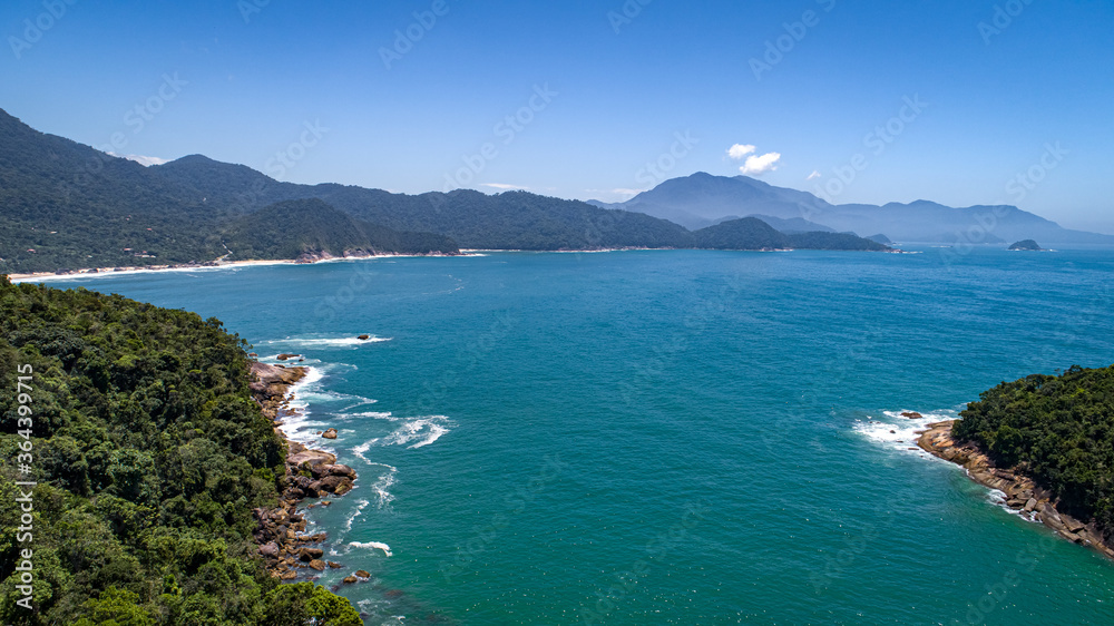 Aerial view to wonderful Green Coast shoreline and mountains covered with Atlantic Forest, Picinguaba, Brazil
