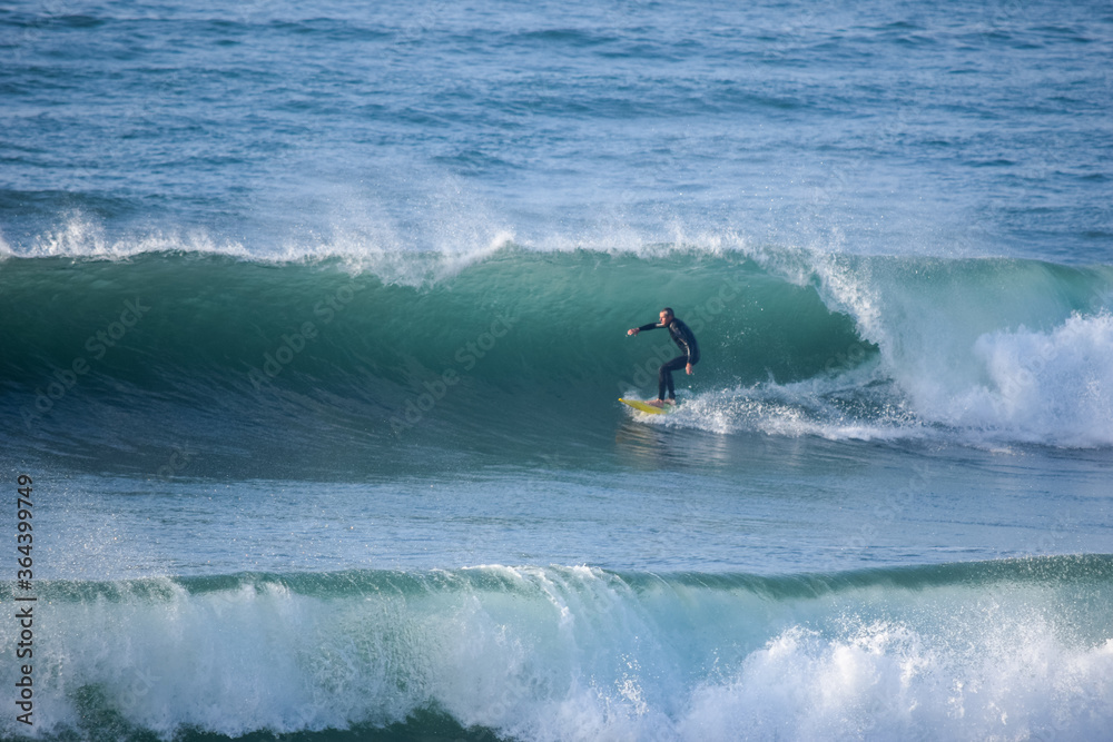 Japan surfing , sometimes during a typhoon, there are many waves in Japan especially in Hebara, Katsuura, Chiba. Westerner surfs large waves. Sunrise & at the beach with a surfer & his surf board. Japan surfing , sometimes during a typhoon, there are many waves in Japan especially in Hebara, Katsuura, Chiba. Westerner surfs large waves. Sunrise & at the beach with a surfer & his surf board.