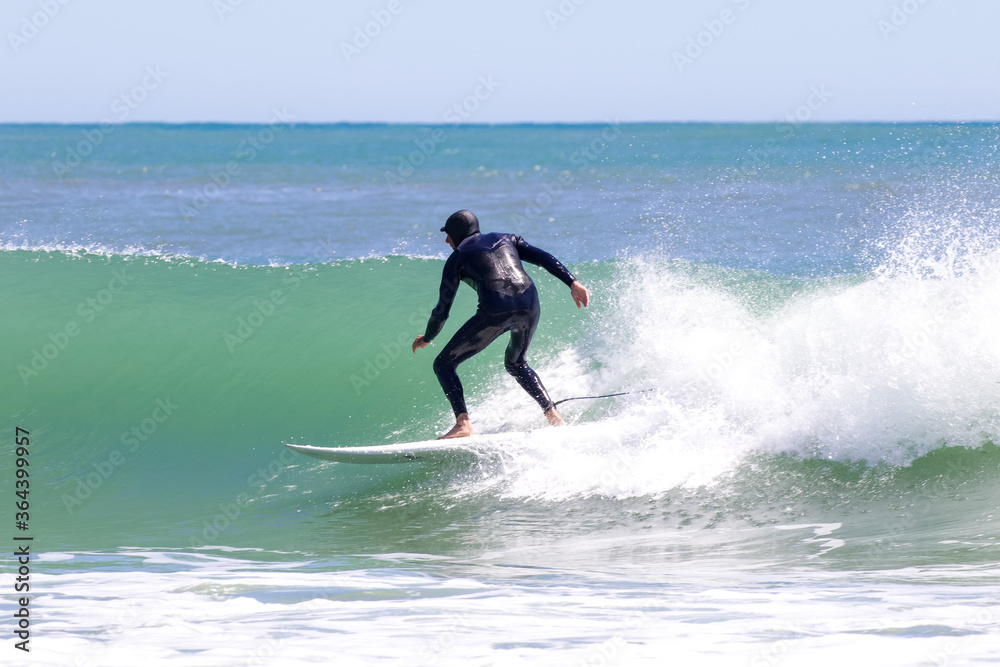 Japan surfing , sometimes during a typhoon, there are many waves in Japan especially in Hebara, Katsuura, Chiba. Westerner surfs large waves. Sunrise & at the beach with a surfer & his surf board. Japan surfing , sometimes during a typhoon, there are many waves in Japan especially in Hebara, Katsuura, Chiba. Westerner surfs large waves. Sunrise & at the beach with a surfer & his surf board.