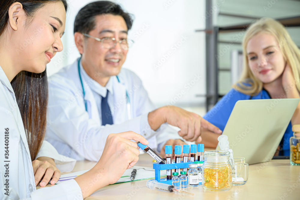 Group of doctors wearing formal white coat and blue scrubs suit, Teamwork brainstorm meeting with computer laptop at the hospital. Group of doctors wearing formal white coat and blue scrubs suit, Teamwork brainstorm meeting with computer laptop at the hospital.