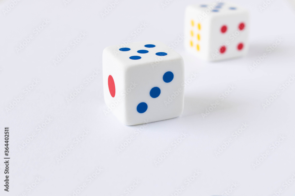 Dice on the light background. Close up. The concept of good luck in gambling. Dice on the light background. Close up. The concept of good luck in gambling.