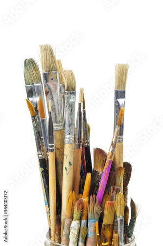 Various used paint brushes on a white background