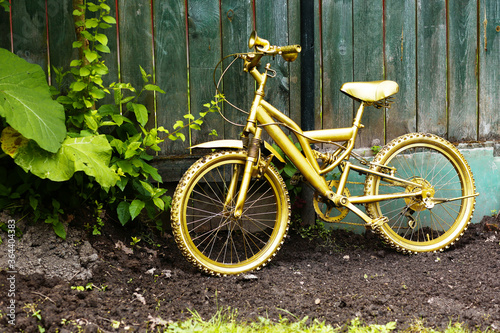 golden bicycle as a formal garden decoration