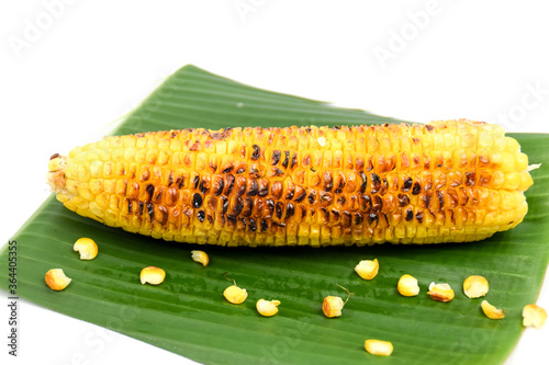 Roasted grilled corn with banana leaf on white background