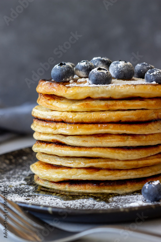 Pancakes with blueberries and honey. Breakfast. Vegetarian food. Recipe.