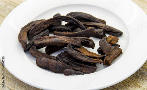 Burnt french fries isolated on a white plate - conceptual image in horizontal format photo