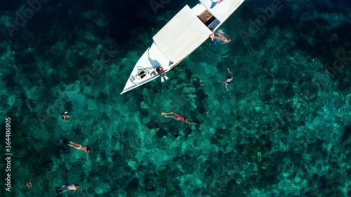 Statues in Gili Island. The infinity and the cycle of life under the sea and the drone shot of the statues from above with a boat near.  photo