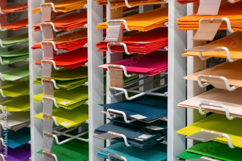 Shelf in store with a lot of colorful blank paper for design and art. Group of multicolored sheets as school, colledge and university tools in shop. photo