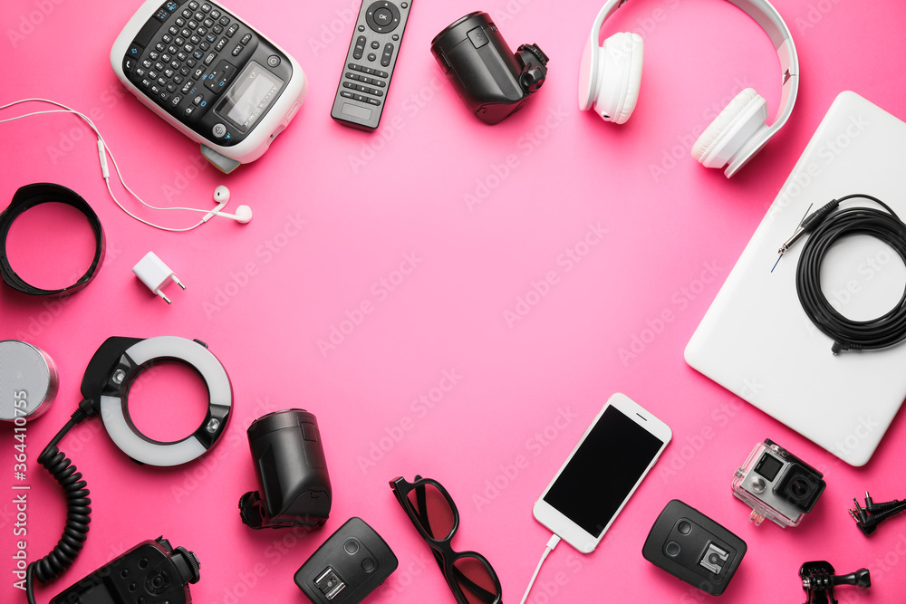 Frame made of different modern devices on color background Frame made of different modern devices on color background