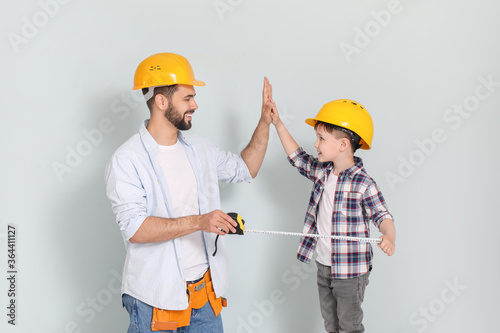 Father and son with measuri...