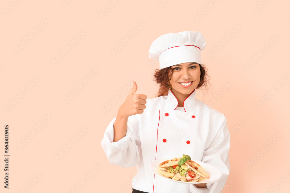 Female African-American chef with tasty dish on color background Female African-American chef with tasty dish on color background