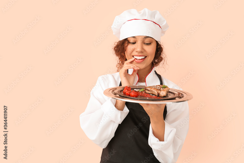 Female African-American chef with tasty dish on color background Female African-American chef with tasty dish on color background