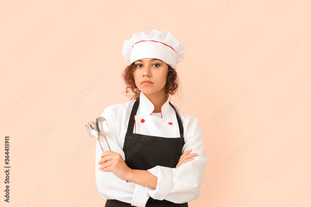 Female African-American chef on color background Female African-American chef on color background