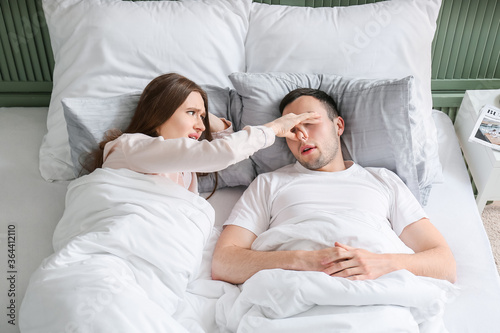 Young irritated woman in be...