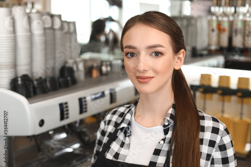 Young female barista at wor...