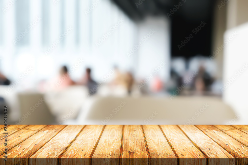 Empty wooden desk space and blurry background of cafe or Restaurant for product display montage.