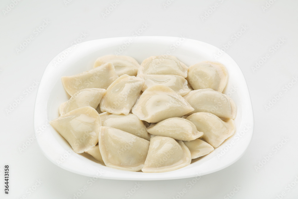boiled dumplings on a white plate white background