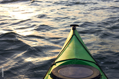 Fotografía View from a green kayak on rippled water surface of the Danube river in golden evening light