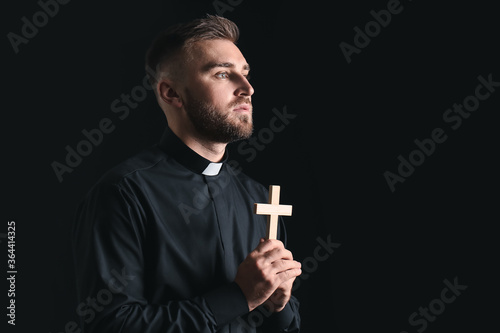 Young priest praying to God...