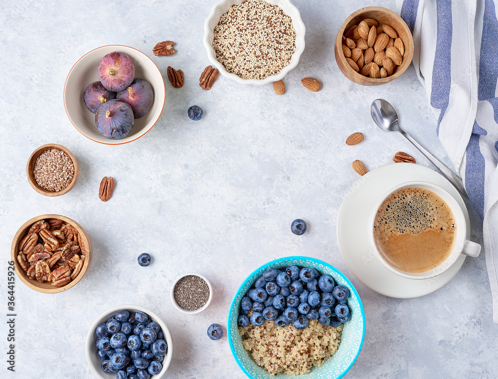 Ingredients for a healthy breakfast, quinoa with blueberry, fig, honey and nuts. Concept vegan and healthy eating. Top view Ingredients for a healthy breakfast, quinoa with blueberry, fig, honey and nuts. Concept vegan and healthy eating. Top view