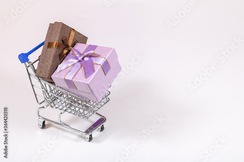 Shopping carts with gifts inside on a white background.