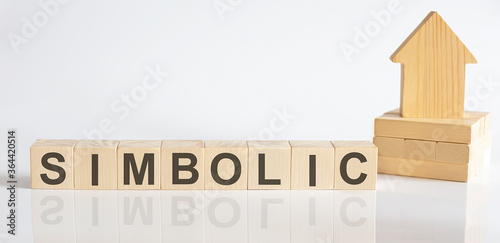 SIMBOLIC -Wooden Blocks With A Miniature House on white background photo