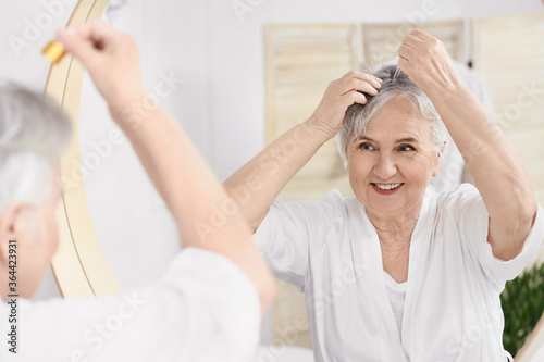 Senior woman using serum fo...