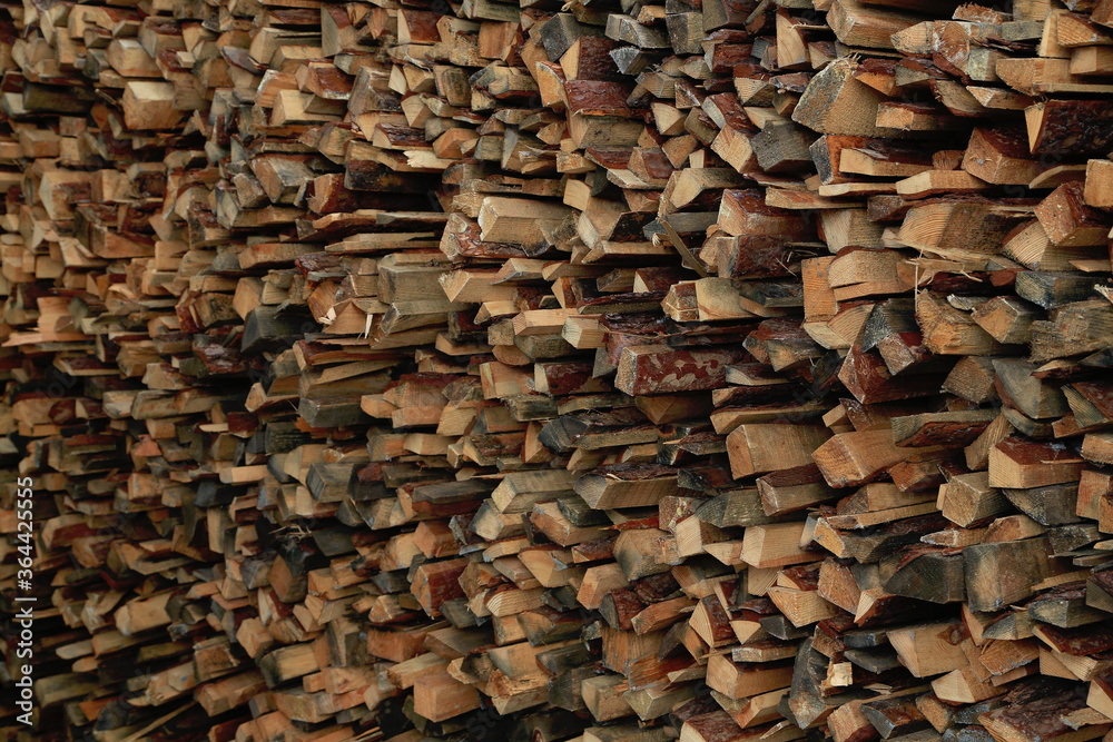 Firewood harvested for the winter. Firewood for the bath folded neatly. Background. Fuel for stove, for bonfire