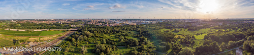 Aerial sunset view on Antwerp North area, with city and harbor in far distance, nature park oude landen in foreground