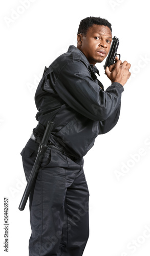 African-American police officer with gun on white background