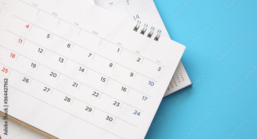 calendar page close up on blue background business planning appointment meeting concept calendar page close up on blue background business planning appointment meeting concept